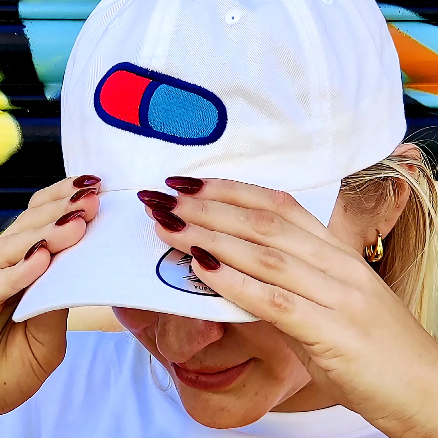 Model Jordyn is wearing white dad hat with Magical Pill embroidery 
