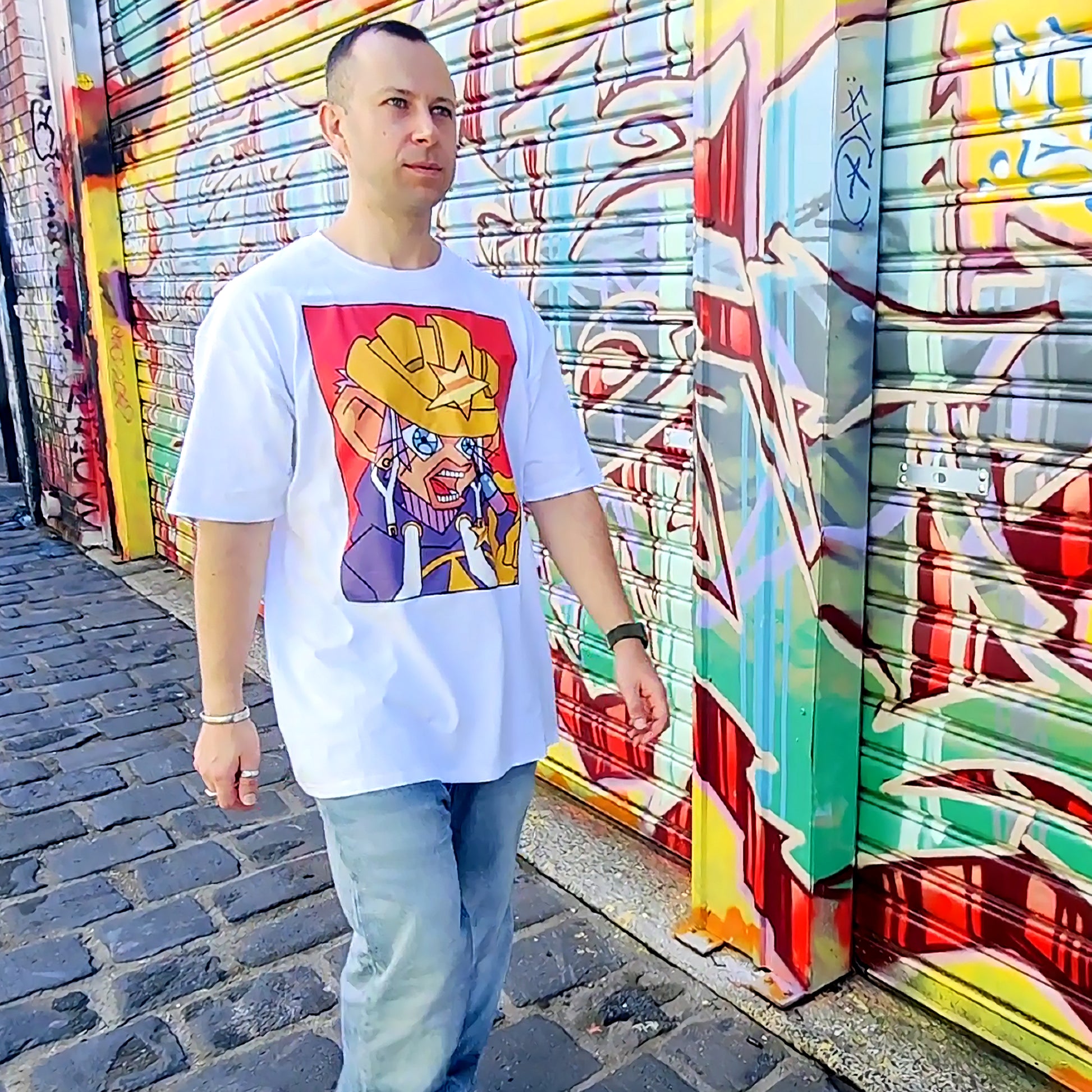 Boy Model Macie-J is walking down the street with a graffiti background, posing and wearing (anime inspired graphic t) Mahou Shounen Star B-Side Kick T Shirt 