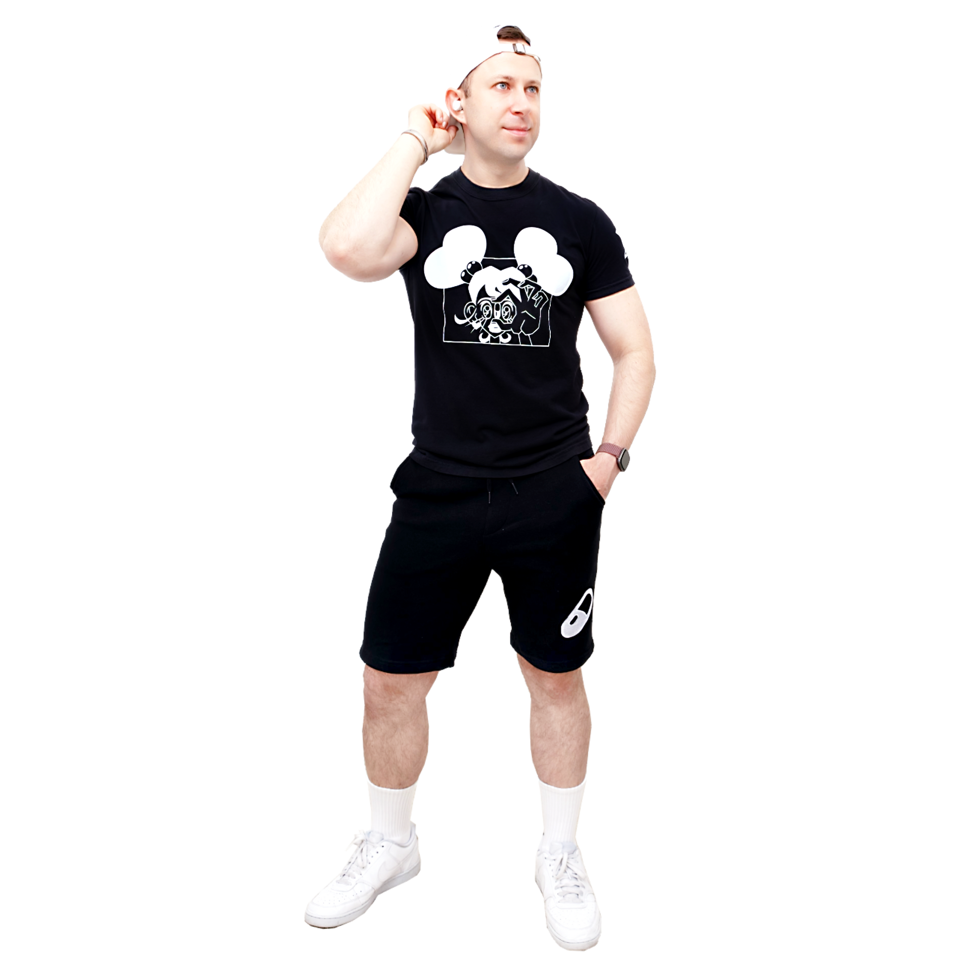 Male model wearing a black t-shirt with a Valentine Pill graphic design and black shorts on a white background.