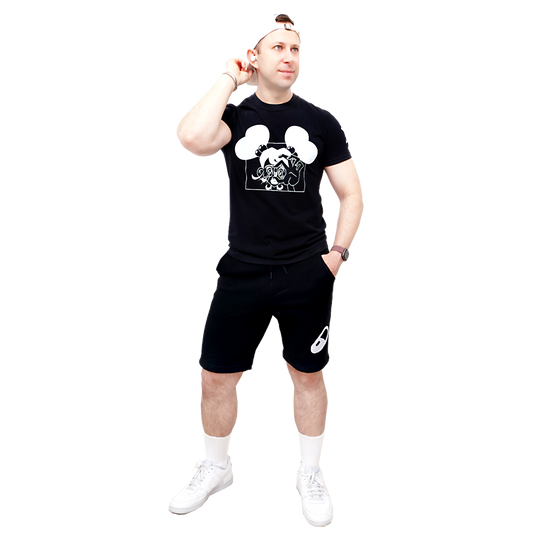 Male model wearing a black t-shirt with a Valentine Pill graphic design and black shorts on a white background.