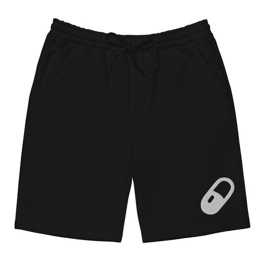 Flat lay of black fleece shorts, front-facing, with a relaxed fit and visible white embroidered pill on the bottom left leg.